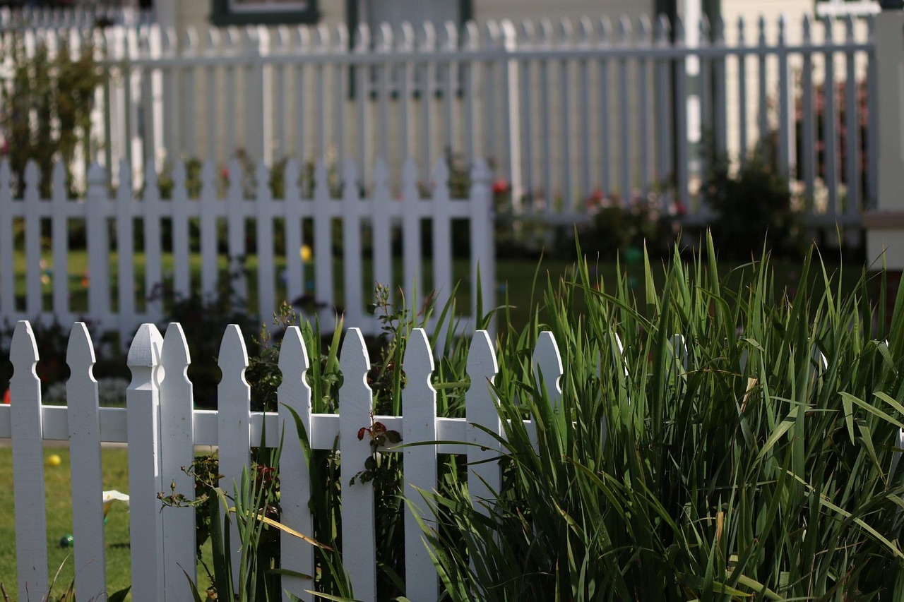 White picket fence running along a residential front yard in Edmond, Oklahoma